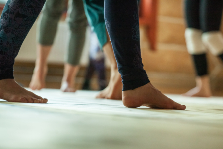 performers foots, legs, on blured background. dancer improvise,on floor, dance performance improvisation